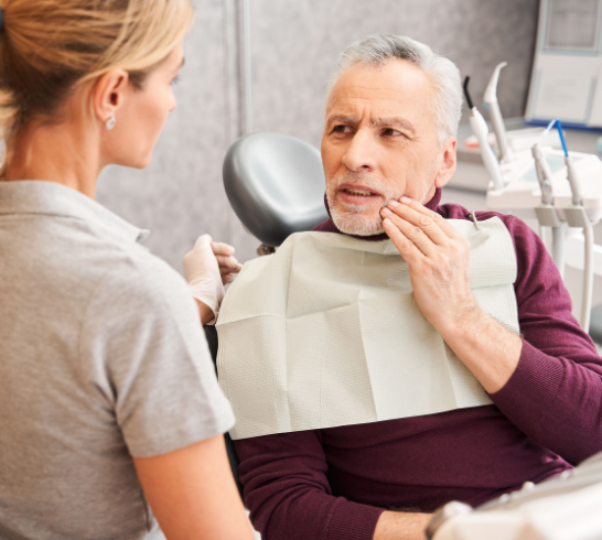 Elderly male patient with toothache talking to his dentist at the clinic. Man suffering of the pain. Aching, inflammation, infection, painful, helping and treatment concept
