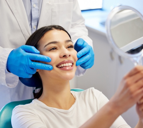 Woman, dentist and happy with mirror for dental surgery in clinic for teeth whitening and treatment with doctor. Female patient, satisfied and smile on consultation for canal procedure and oral care